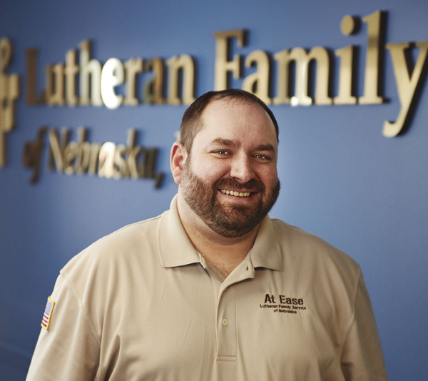Adam Armstrong in front of Lutheran Family Services sign