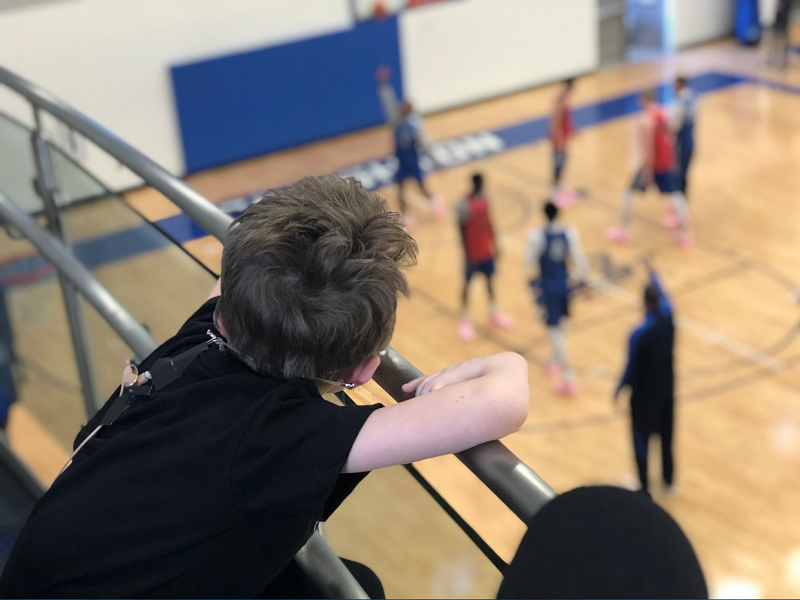 Cale Ferrin watches the Bluejays practice from the gym balcony