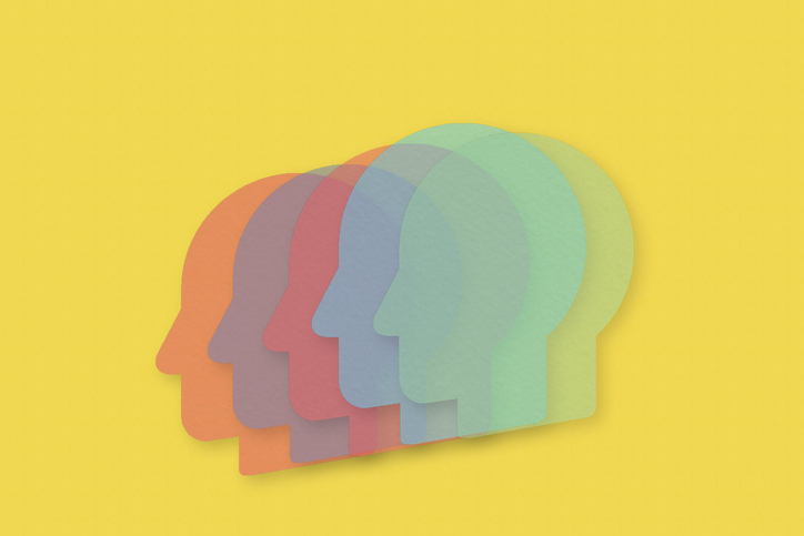 Colorful semi-transparent paper heads in row. Yellow bright background.