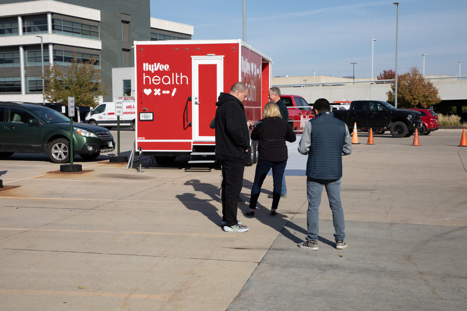 People stand outside a mobile flu shot clinic